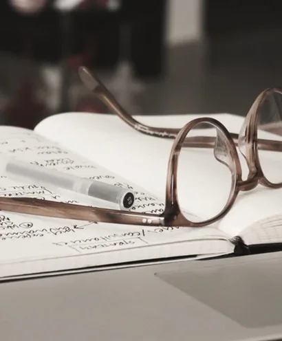 Notebook and glasses for project planning